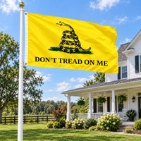 Don't Tread On Me Gadsden Flag 3x5 flying on a flagpole outside a farmhouse