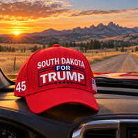South Dakota embroidered red hat on a truck dashboard at sunset (lifestyle)