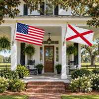American flag and Alabama State Flag flying side by side outdoors