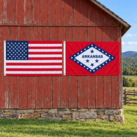 American flag and Arkansas State Flag flying side by side outdoors