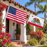 American flag and California State Flag flying side by side outdoors