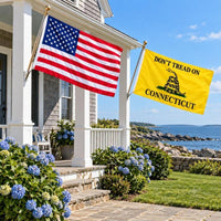 American flag and Don't Tread on Connecticut flag flying side by side outdoors