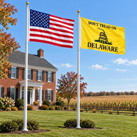 American flag and Don't Tread on Delaware flag flying side by side outdoors
