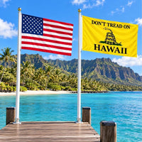 American flag and Don't Tread on Hawaii flag flying side by side outdoors