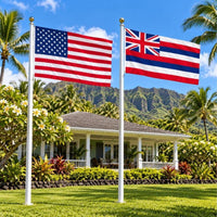 American flag and Hawaii State Flag flying side by side outdoors