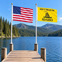 American flag and Don't Tread on Idaho flag flying side by side outdoors