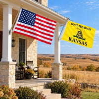 American flag and Don't Tread on Kansas flag flying side by side outdoors
