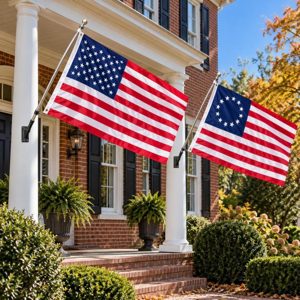 American flag and Betsy Ross flag flying side by side outdoors