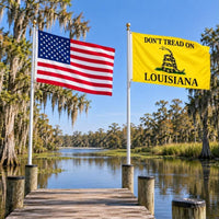 American flag and Don't Tread on Louisiana flag flying side by side outdoors