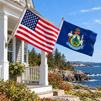 American flag and Maine State Flag flying side by side outdoors