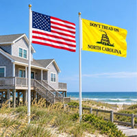 American flag and Don't Tread on North Carolina flag flying side by side outdoors