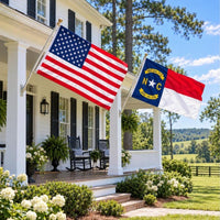 American flag and North Carolina State Flag flying side by side outdoors