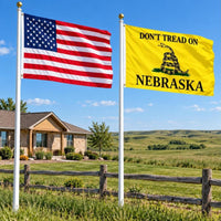 American flag and Don't Tread on Nebraska flag flying side by side outdoors