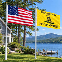 American flag and Don't Tread on New Hampshire flag flying side by side outdoors