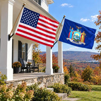 American flag and New York State Flag flying side by side outdoors