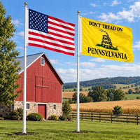 American flag and Don't Tread on Pennsylvania flag flying side by side outdoors