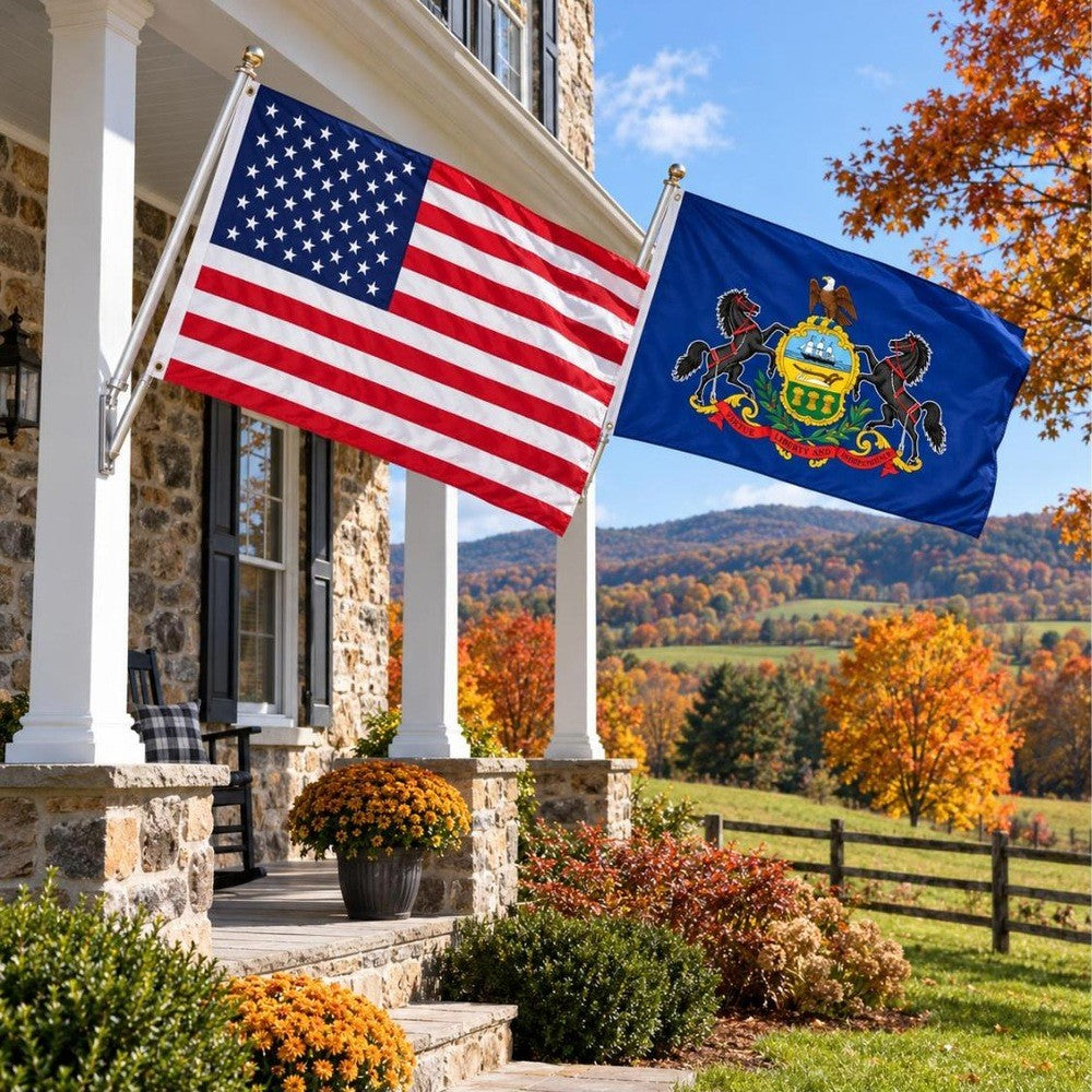 American flag and Pennsylvania State Flag flying side by side outdoors