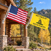 American flag and Don't Tread on South Dakota flag flying side by side outdoors