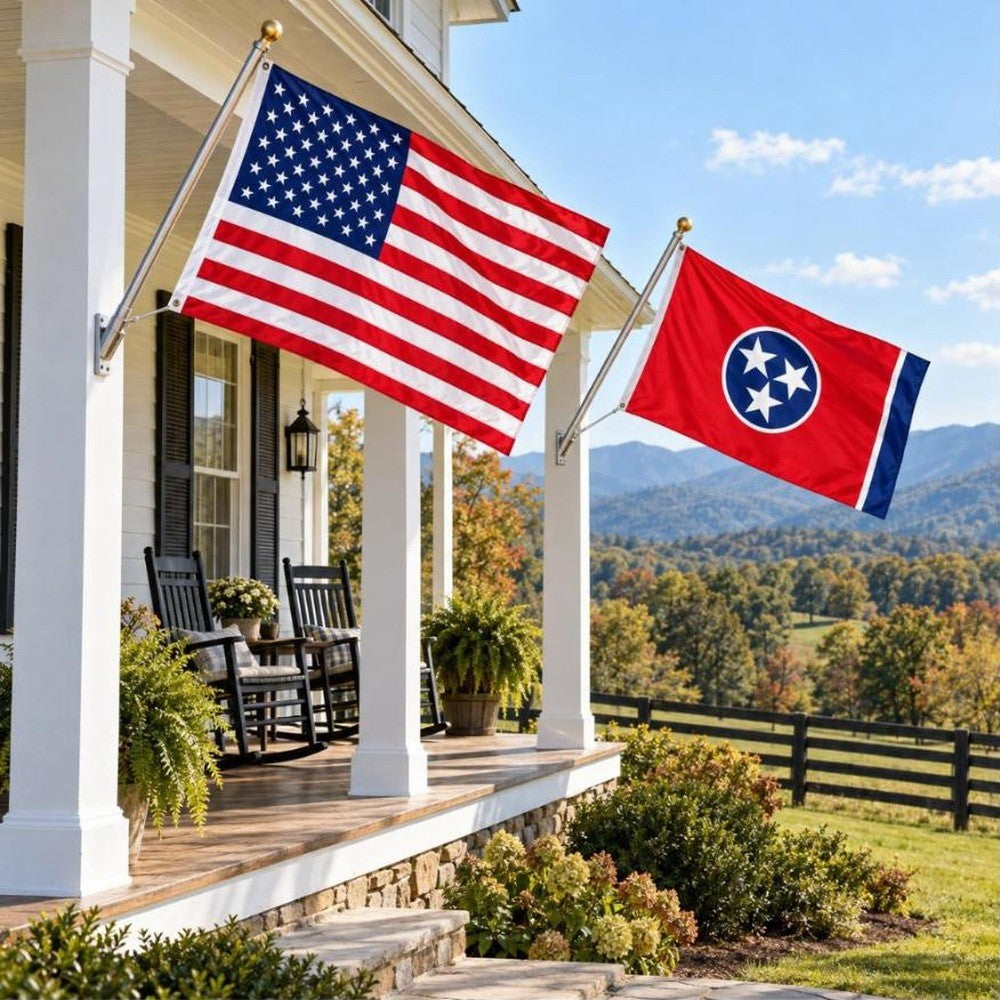 American flag and Tennessee State Flag flying side by side outdoors