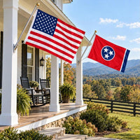 American flag and Tennessee State Flag flying side by side outdoors