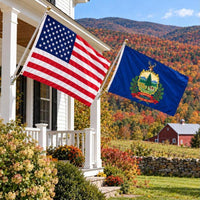 American flag and Vermont State Flag flying side by side outdoors