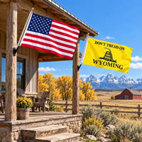 American flag and Don't Tread on Wyoming flag flying side by side outdoors