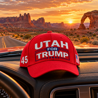 Utah embroidered red hat on a truck dashboard at sunset (lifestyle)