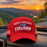 West Virginia embroidered red hat on a truck dashboard at sunset (lifestyle)