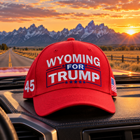 Wyoming embroidered red hat on a truck dashboard at sunset (lifestyle)